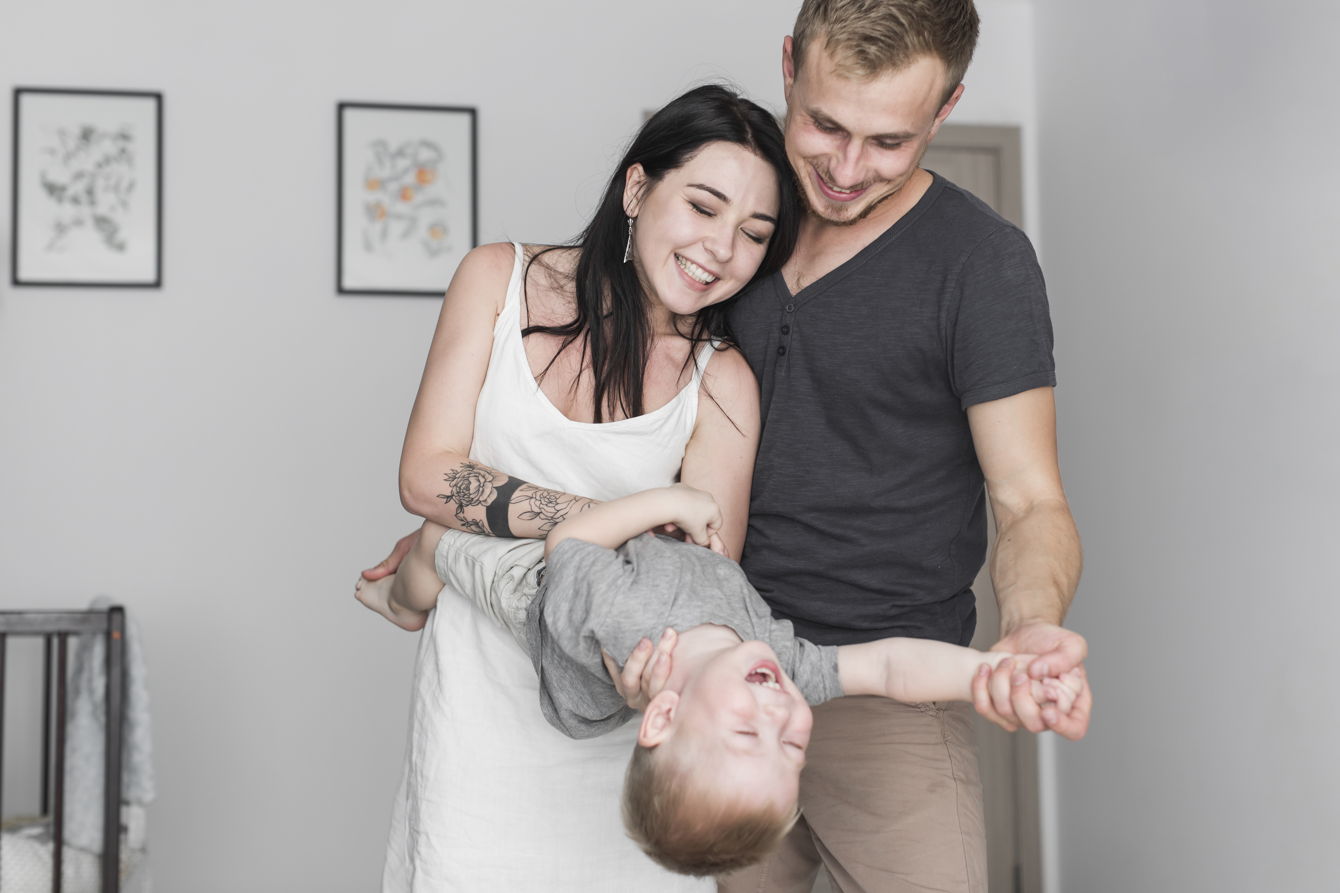 smiling-young-couple-playing-with-their-son-home (1).jpg